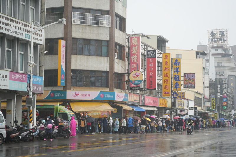 屏東都城隍廟發錢母 人龍雨中綿延數公里